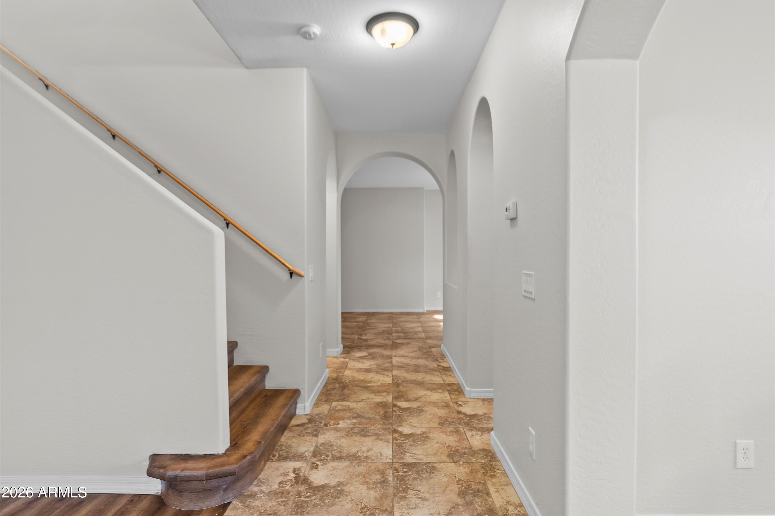 955 South Henry Lane Gilbert, AZ 85296 - Photo 12 of 40 a view of a hallway with wooden floor and staircase