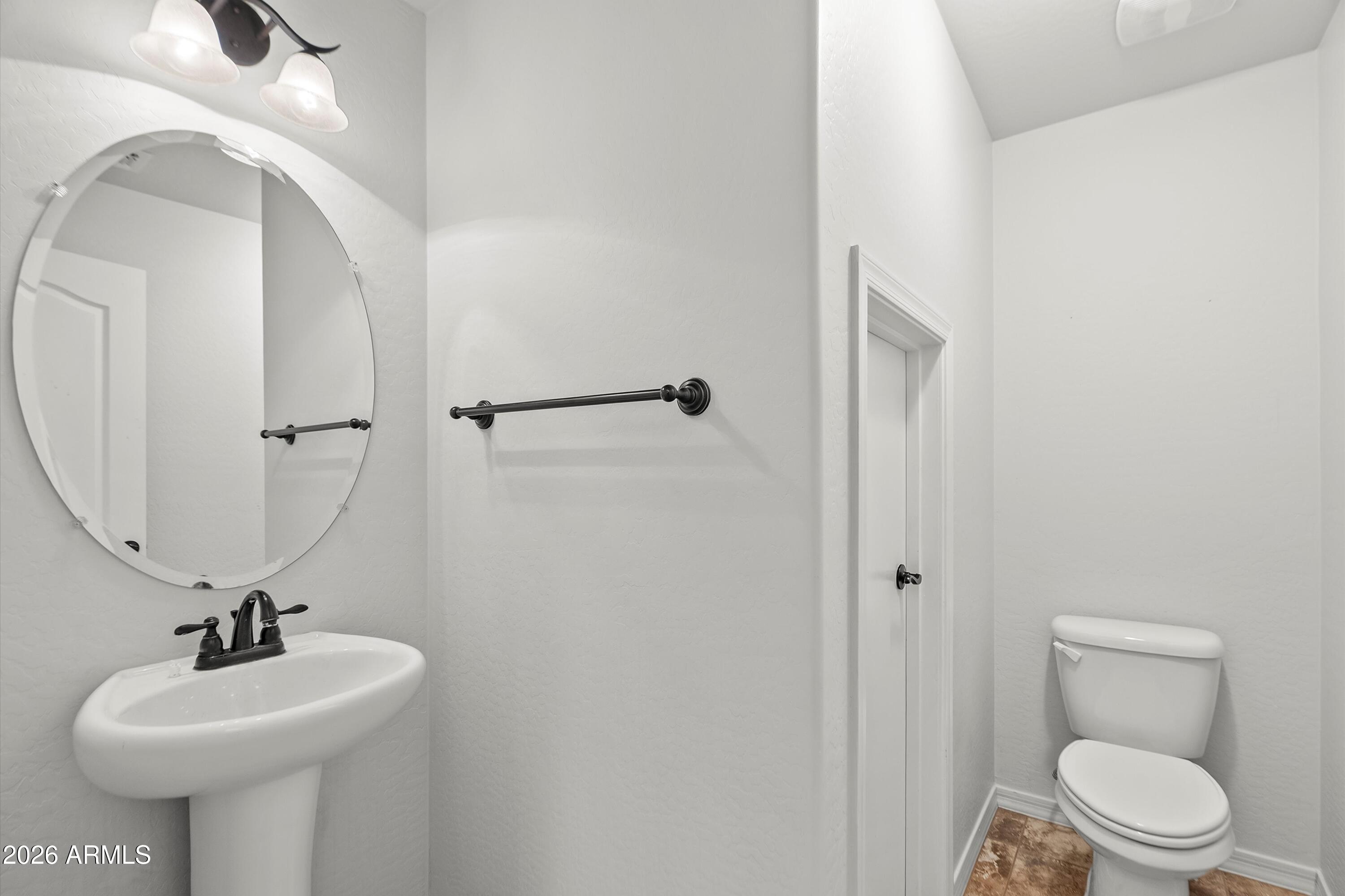 955 South Henry Lane Gilbert, AZ 85296 - Photo 13 of 40 a bathroom with a sink a toilet and mirror