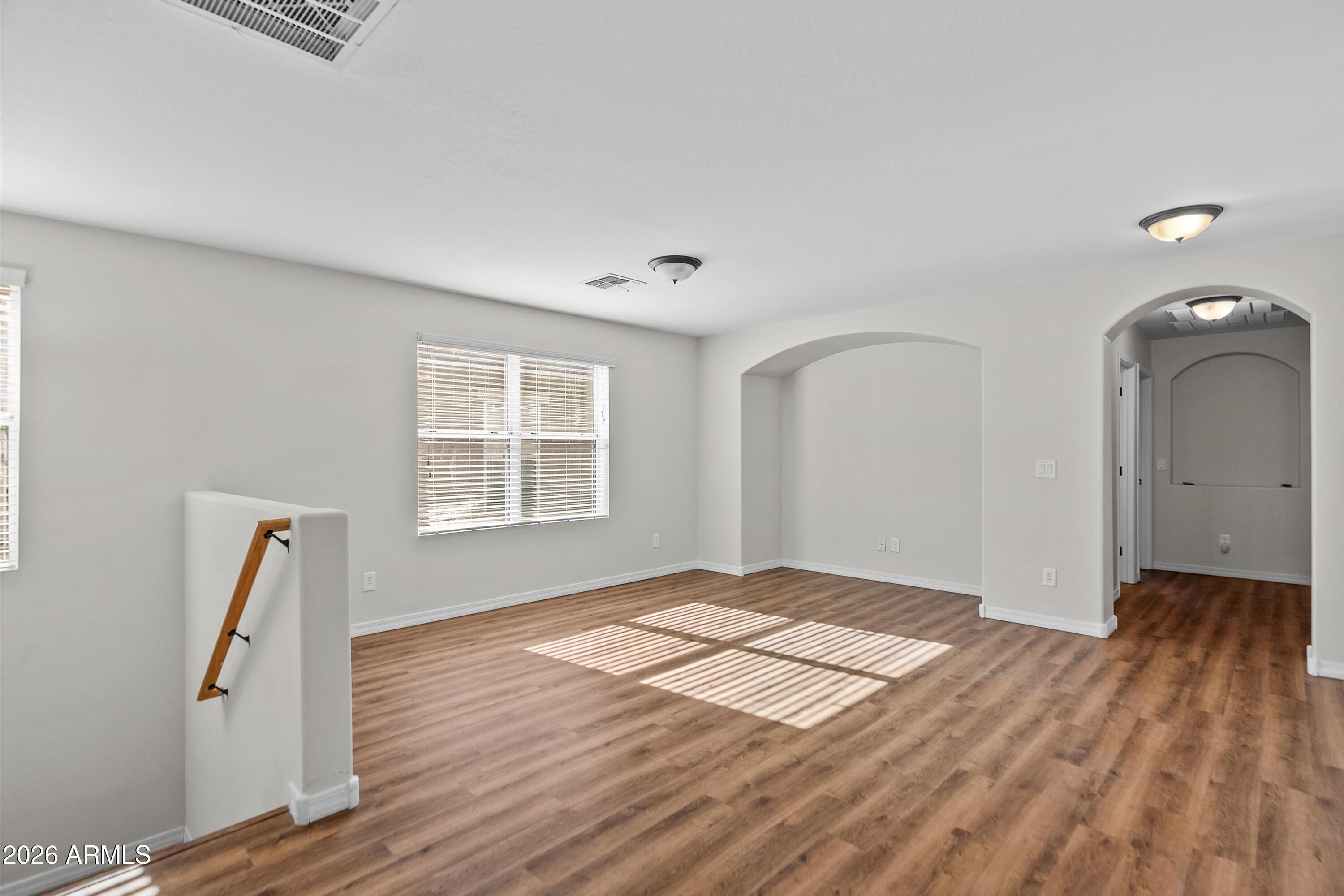 955 South Henry Lane Gilbert, AZ 85296 - Photo 17 of 40 a view of empty room with wooden floor and fan