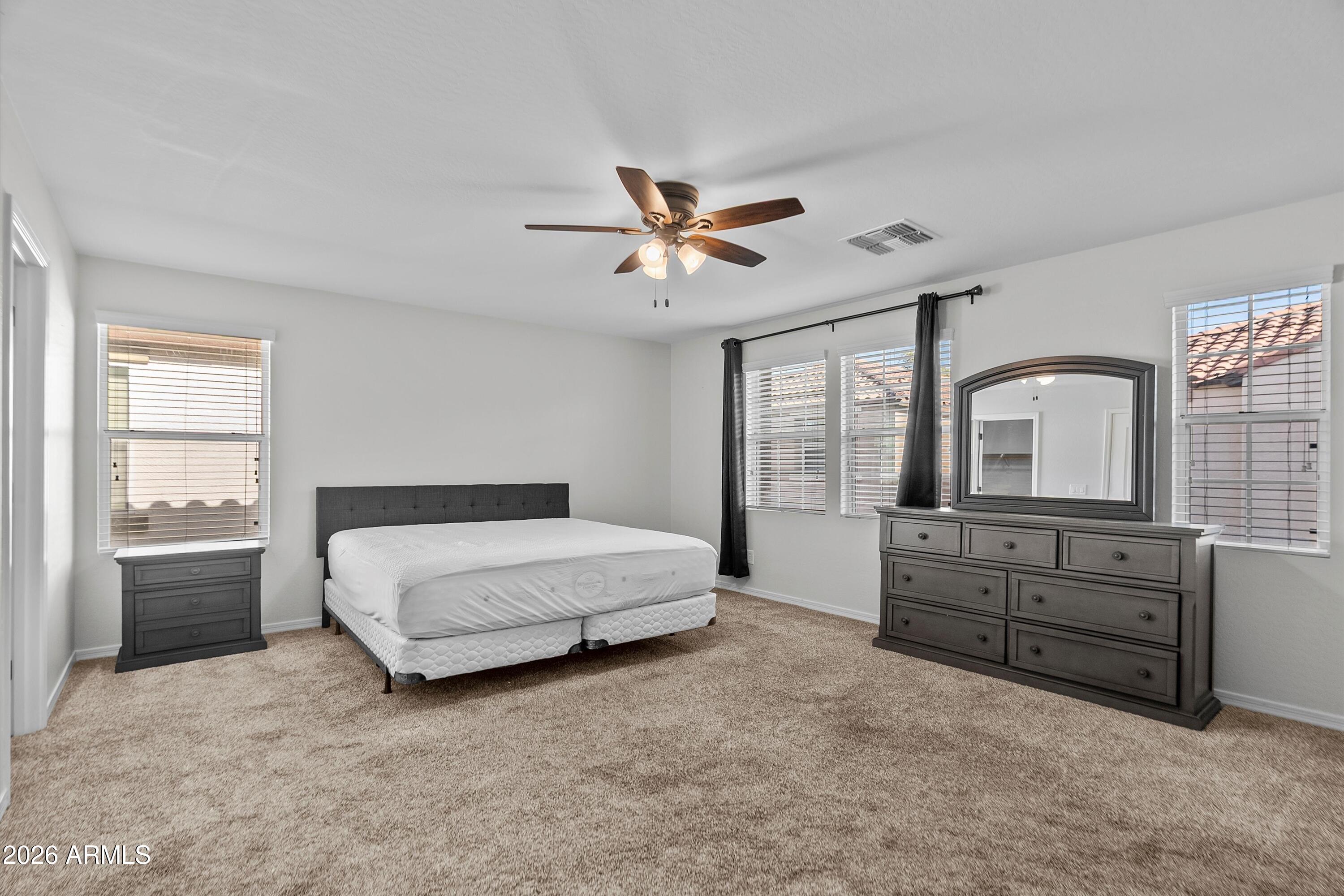 955 South Henry Lane Gilbert, AZ 85296 - Photo 20 of 40 a spacious bedroom with a bed and a large window with balcony view