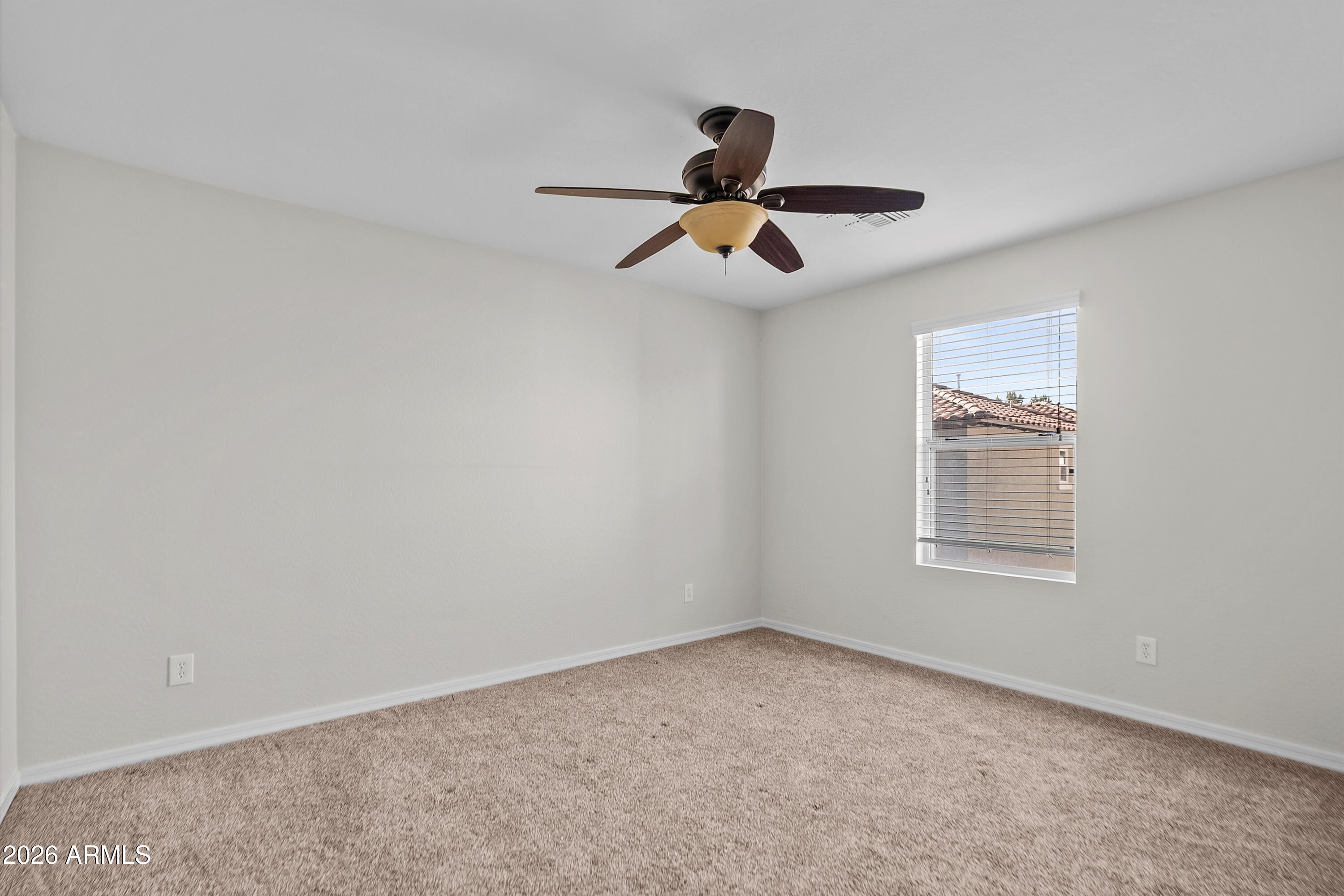 955 South Henry Lane Gilbert, AZ 85296 - Photo 27 of 40 an empty room with a ceiling fan and window