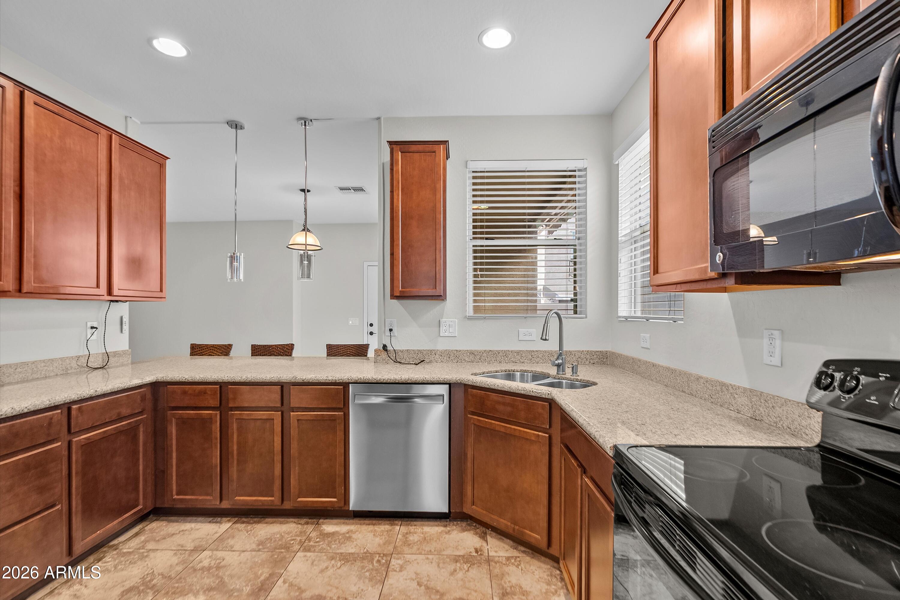 955 South Henry Lane Gilbert, AZ 85296 - Photo 5 of 40 a kitchen with a sink stove and cabinets