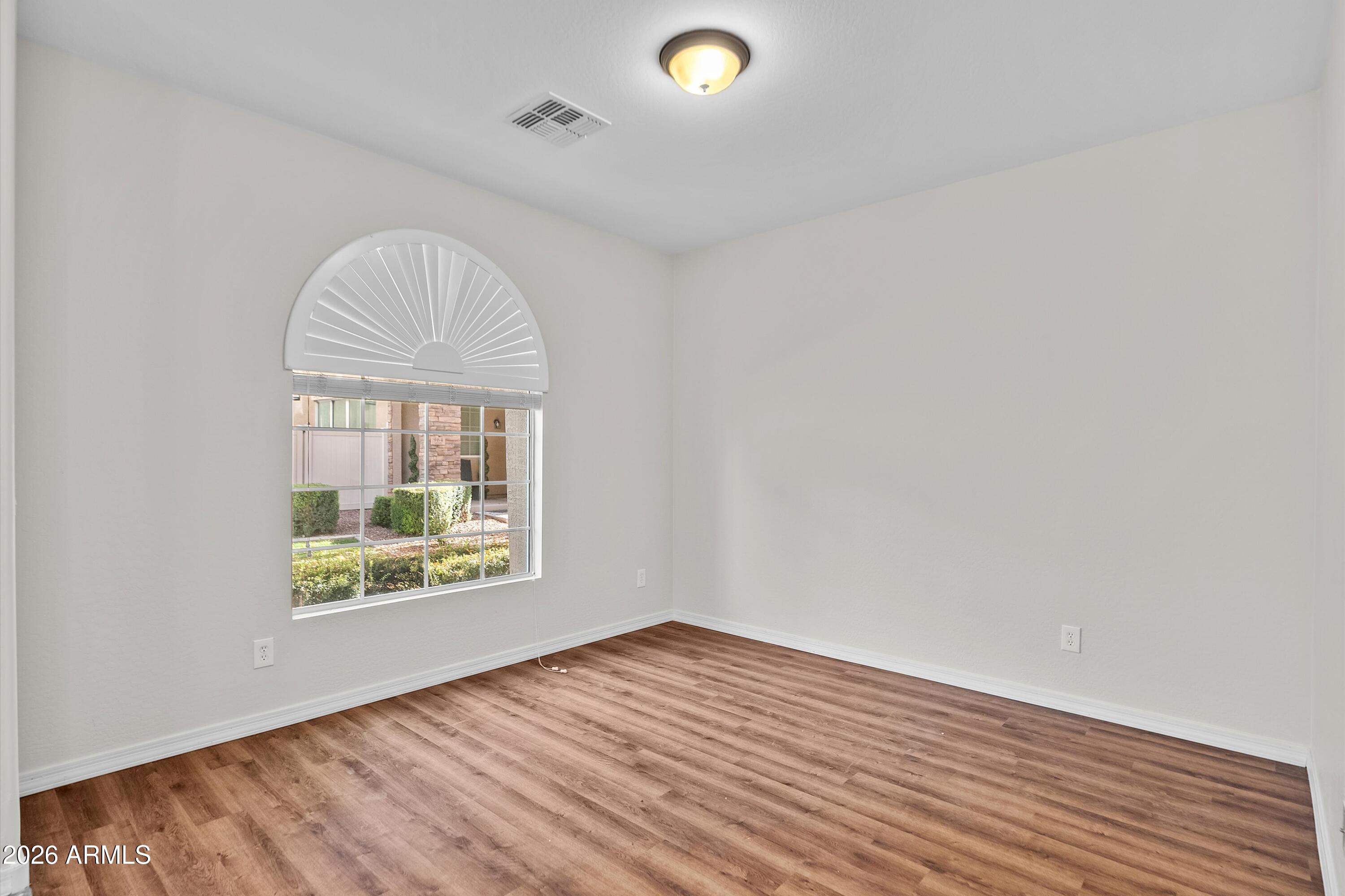 955 South Henry Lane Gilbert, AZ 85296 - Photo 10 of 40 an empty room with wooden floor and windows
