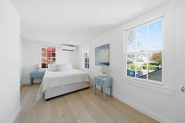 a bathroom with a toilet sink vanity and mirror