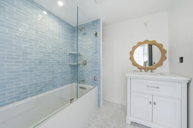 a dining room with furniture and a potted plant