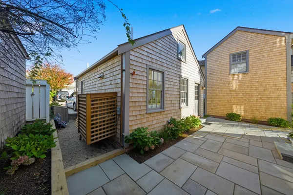 a living room with furniture and a dining table with wooden floor
