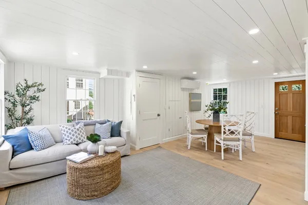a living room with furniture wooden floor and a table