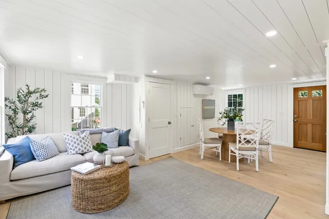 a living room with furniture wooden floor and a table