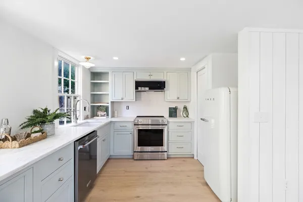 a kitchen with a sink stove and cabinets