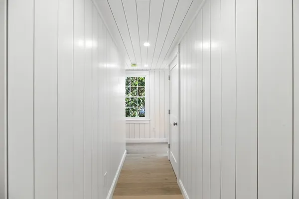 a bedroom with a bed and a mirror