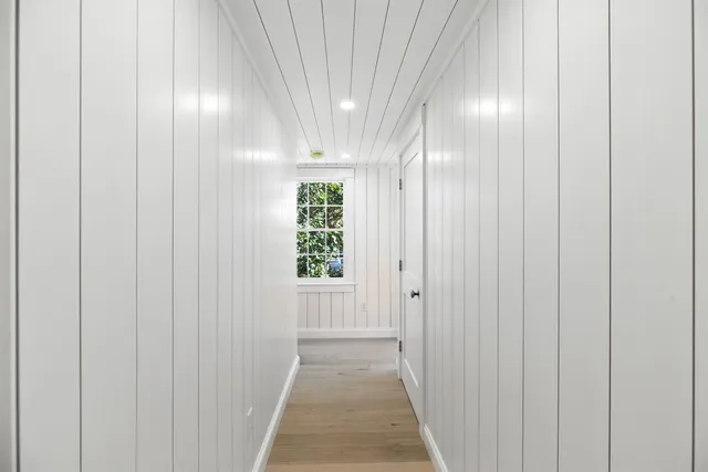 a bedroom with a bed and a mirror