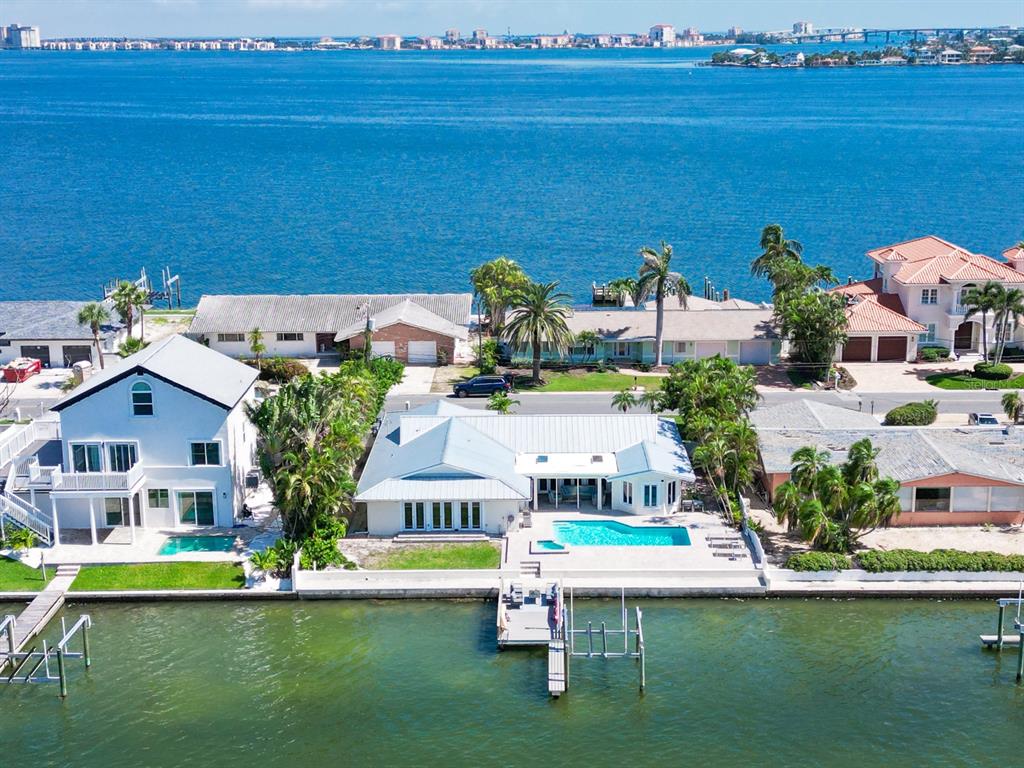 a aerial view of a house with a garden and lake view