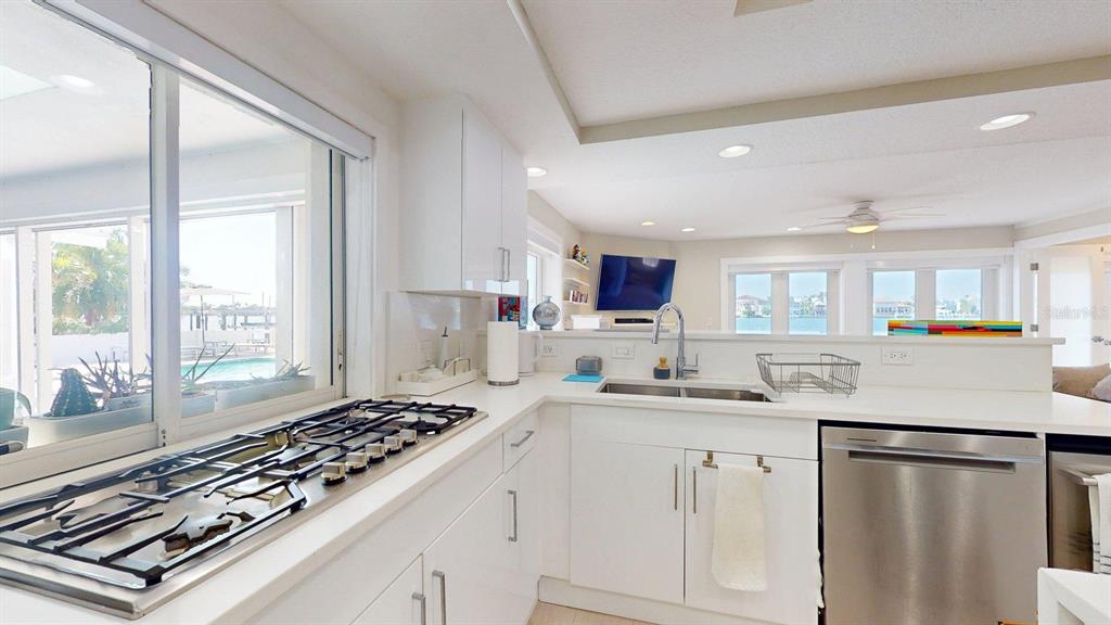 509 55th Avenue St. Pete Beach, FL 33706 - Photo 23 of 63 a kitchen with sink stove and refrigerator