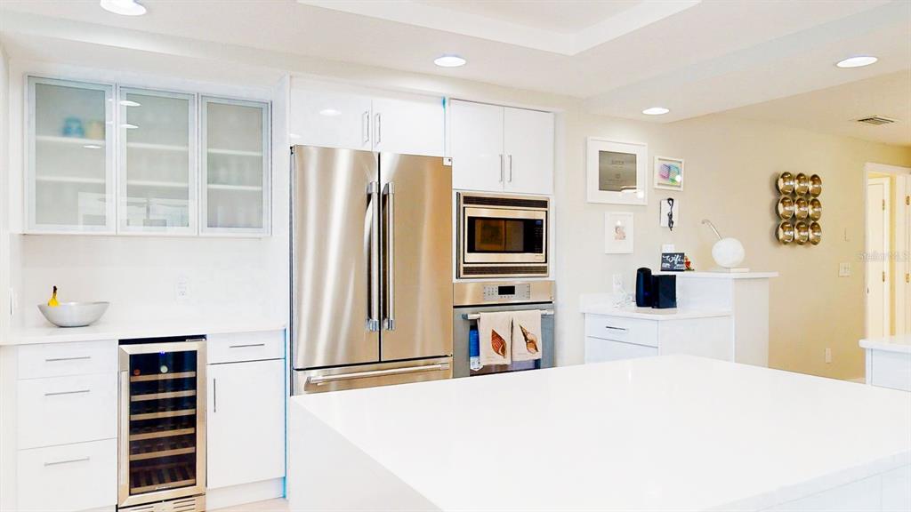 509 55th Avenue St. Pete Beach, FL 33706 - Photo 25 of 63 a kitchen with stainless steel appliances a refrigerator and a stove top oven