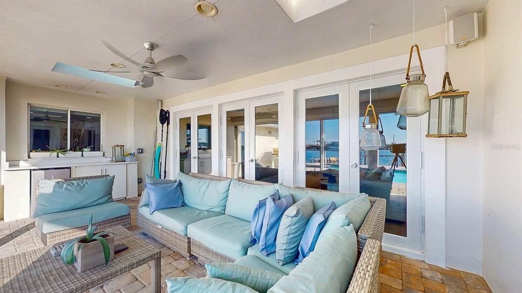 509 55th Avenue St. Pete Beach, FL 33706 - Photo 31 of 63 a living room with furniture and a flat screen tv