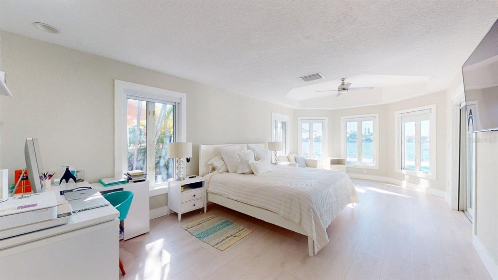 509 55th Avenue St. Pete Beach, FL 33706 - Photo 33 of 63 a bedroom with a bed and large windows