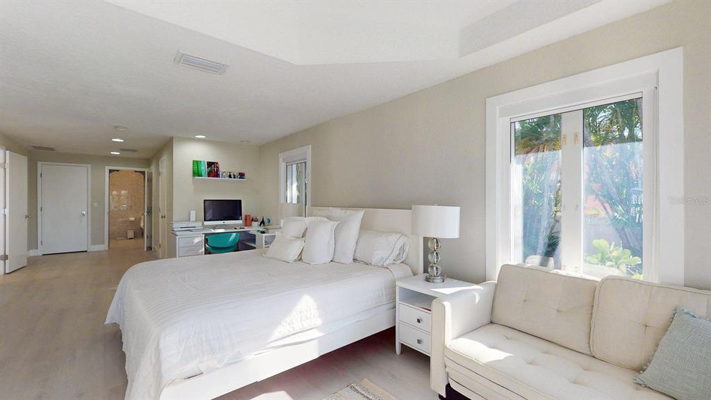 509 55th Avenue St. Pete Beach, FL 33706 - Photo 35 of 63 a bed room with a bed and a couch