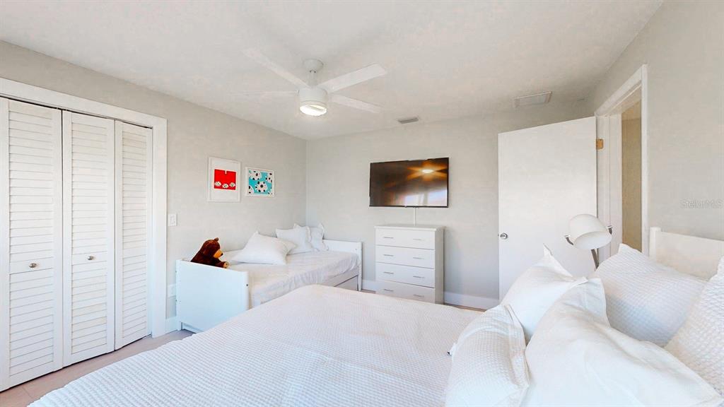 509 55th Avenue St. Pete Beach, FL 33706 - Photo 42 of 63 a bedroom with a bed and a flat screen tv