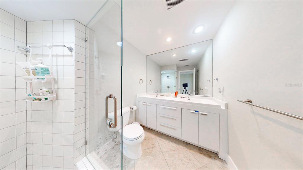 509 55th Avenue St. Pete Beach, FL 33706 - Photo 44 of 63 a bathroom with a double vanity sink toilet and shower