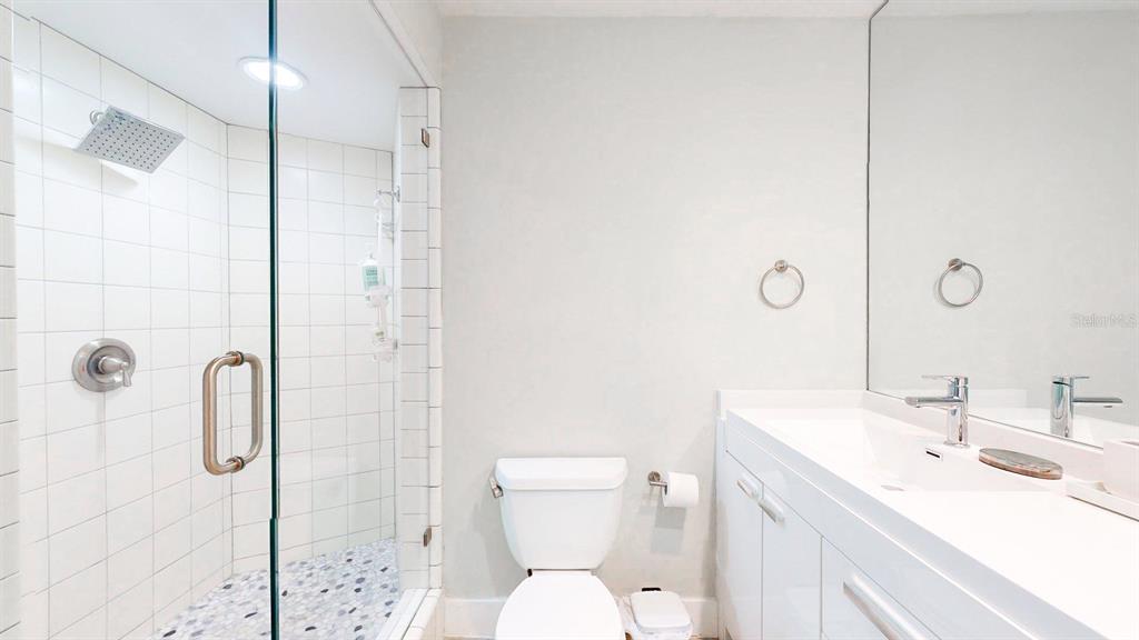509 55th Avenue St. Pete Beach, FL 33706 - Photo 45 of 63 a bathroom with a sink a toilet and shower