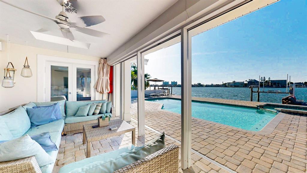 509 55th Avenue St. Pete Beach, FL 33706 - Photo 5 of 63 a living room with couch and a floor to ceiling window
