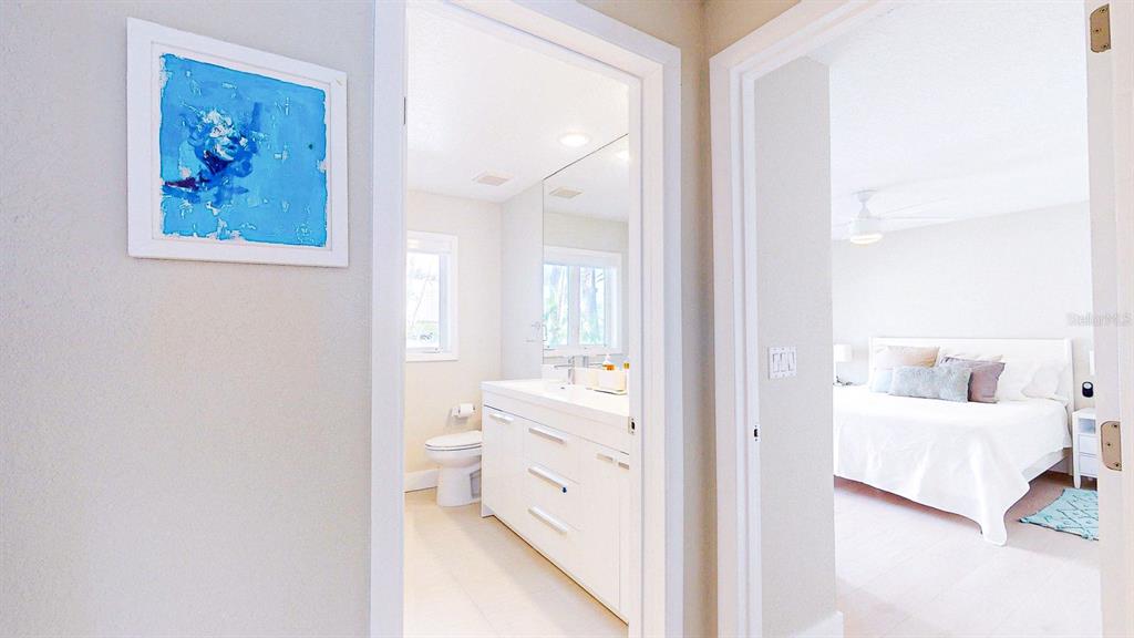 509 55th Avenue St. Pete Beach, FL 33706 - Photo 53 of 63 a en suite bathroom with a toilet sink and vanity