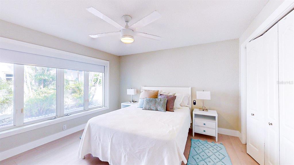 509 55th Avenue St. Pete Beach, FL 33706 - Photo 54 of 63 a bedroom with a bed and a large window