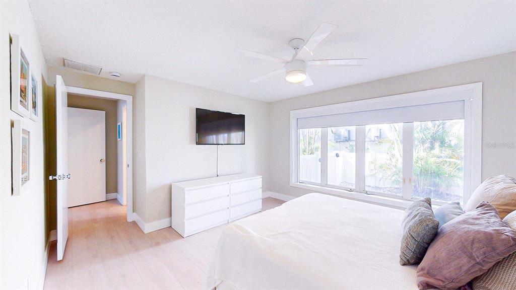 509 55th Avenue St. Pete Beach, FL 33706 - Photo 55 of 63 a spacious bedroom with a bed and a large window