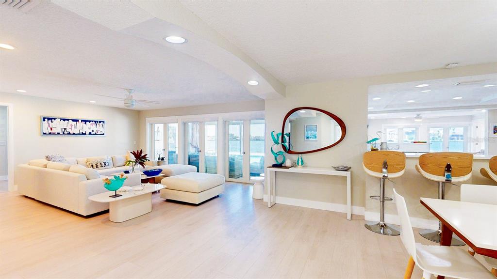509 55th Avenue St. Pete Beach, FL 33706 - Photo 10 of 63 a living room with furniture a chandelier and a large window