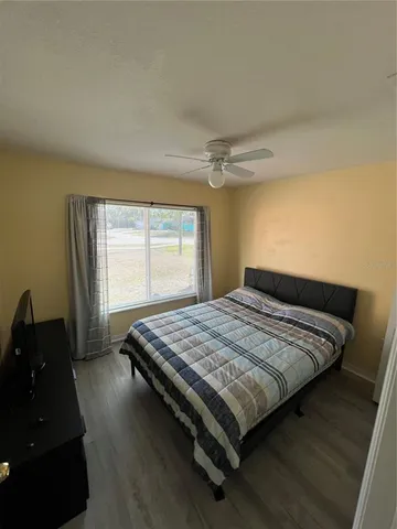 a bed sitting in a bedroom next to a window