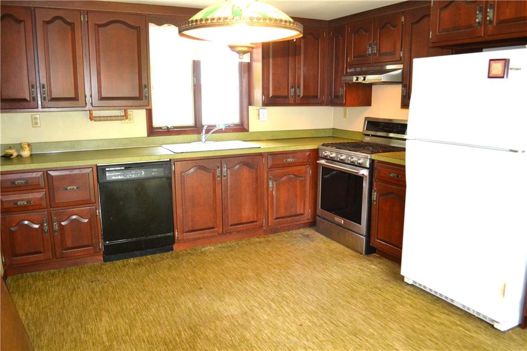 131 Weckerly Road Butler, PA 16002 - Photo 4 of 25 a kitchen with stainless steel appliances granite countertop a stove a sink and a refrigerator