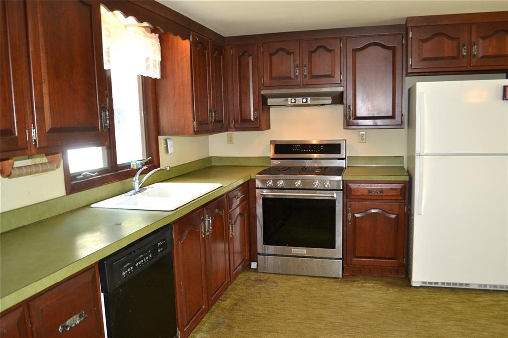 131 Weckerly Road Butler, PA 16002 - Photo 5 of 25 a kitchen with stainless steel appliances granite countertop a stove a sink and a microwave