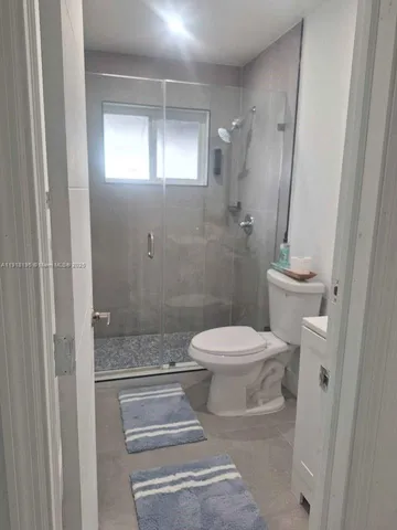 a bathroom with a toilet and a shower