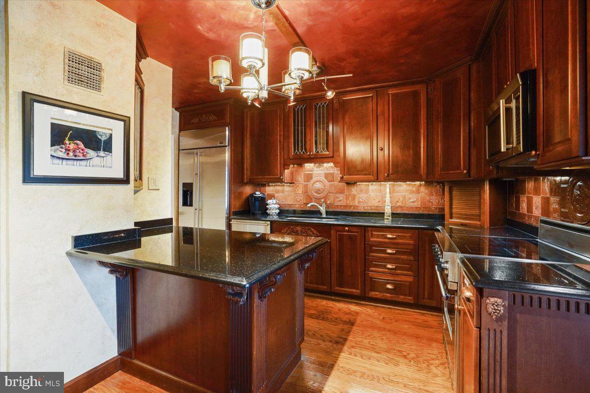 800 25th Street Northwest, Unit 504 Washington, DC 20037 - Photo 21 of 52 Elegant kitchen with rich wood tones.