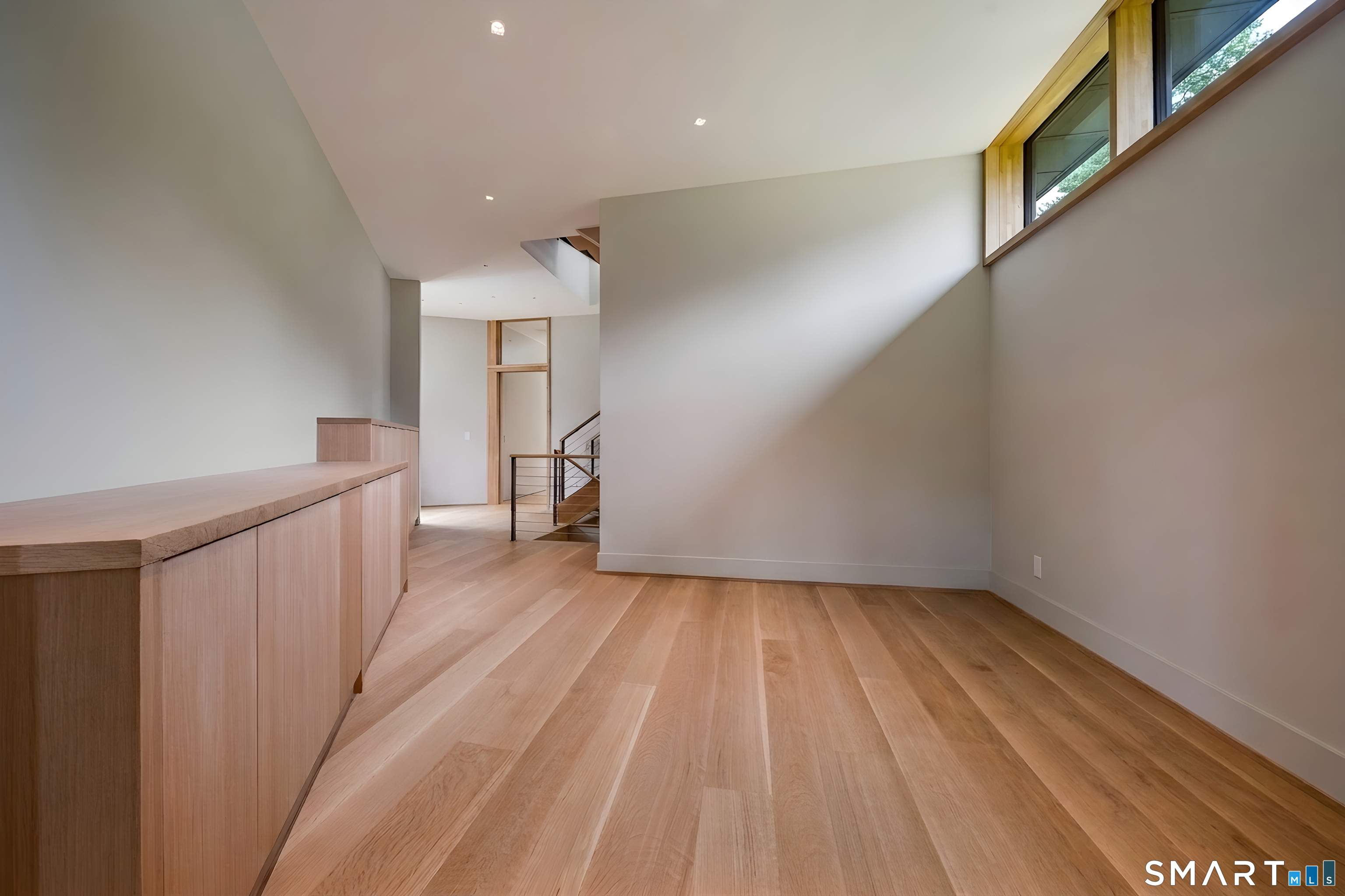 314 Ferry Road Old Lyme, CT 06371 - Photo 16 of 39 a view of a hallway with wooden floor and staircase