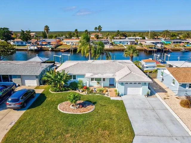 a view of a house with a yard and lake view