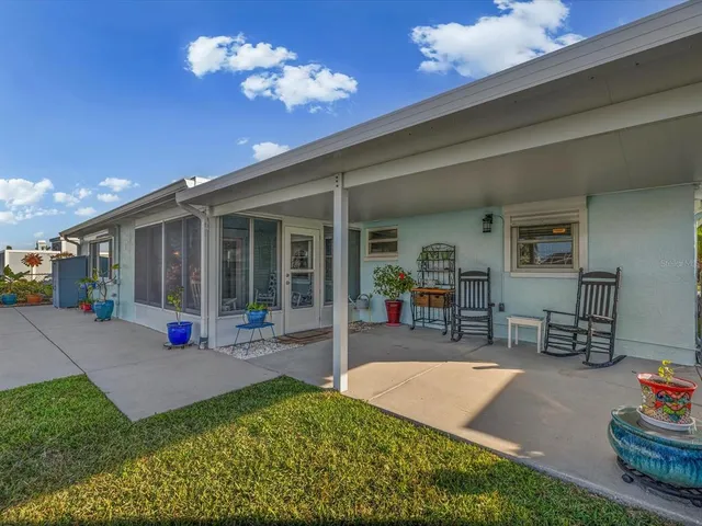 a view of a house with backyard porch and sitting area