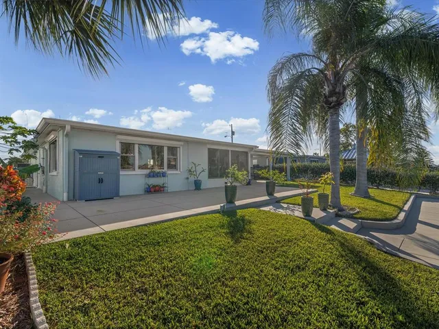 an aerial view of ocean and residential houses with outdoor space
