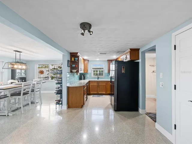 a kitchen with stainless steel appliances granite countertop a refrigerator and a sink