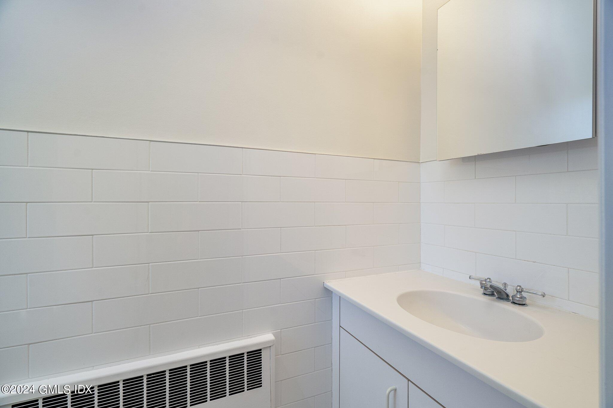 14 Byram Shore Road, Unit 1 Greenwich, CT 06830 - Photo 12 of 19 a bathroom with a sink and vanity