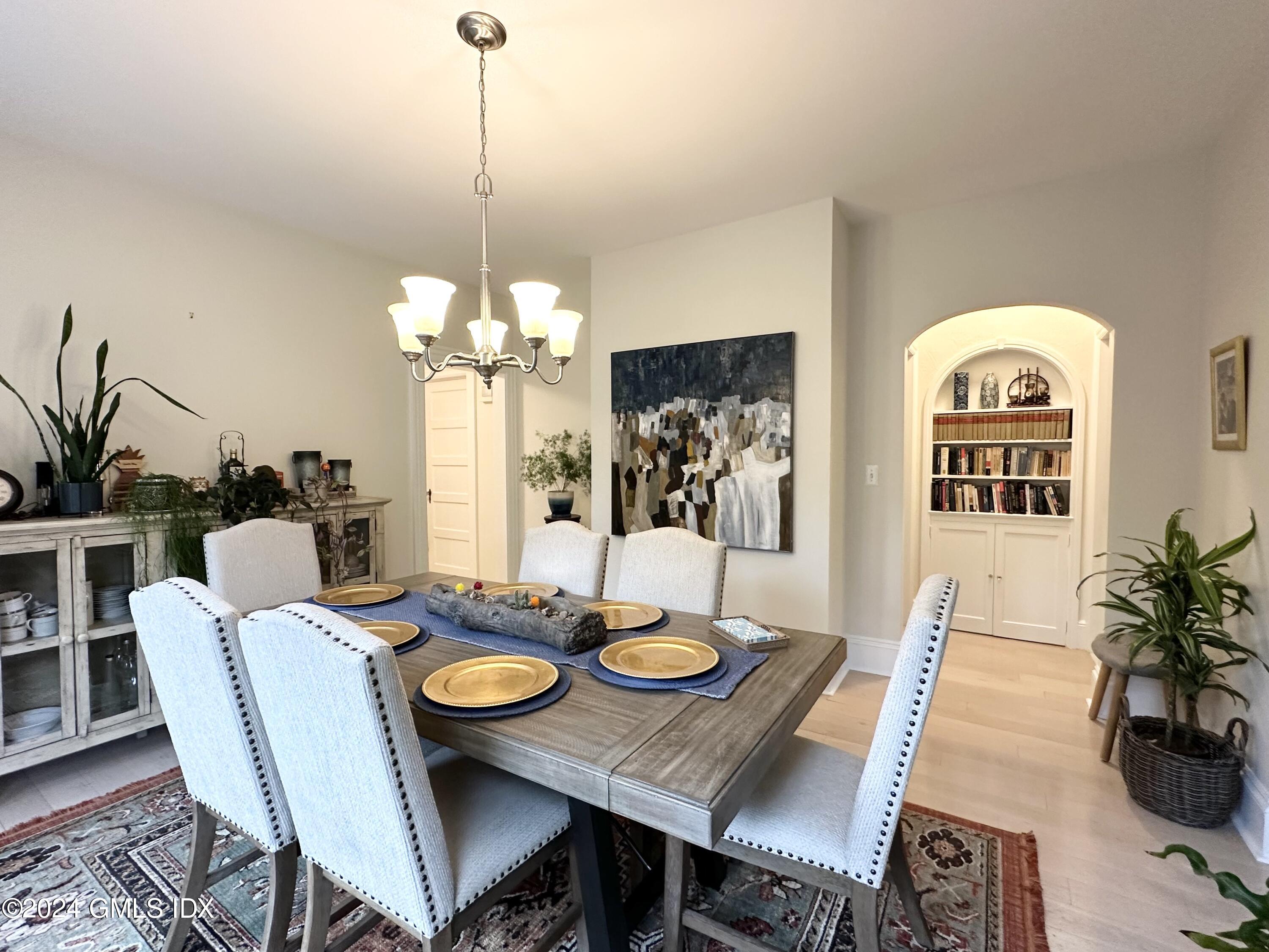 14 Byram Shore Road, Unit 1 Greenwich, CT 06830 - Photo 6 of 19 a view of a dining room with furniture window and wooden floor