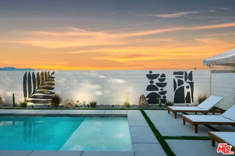a view of a house with pool and a yard