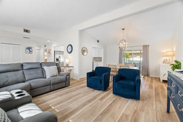 a living room with couches and painting on the wall