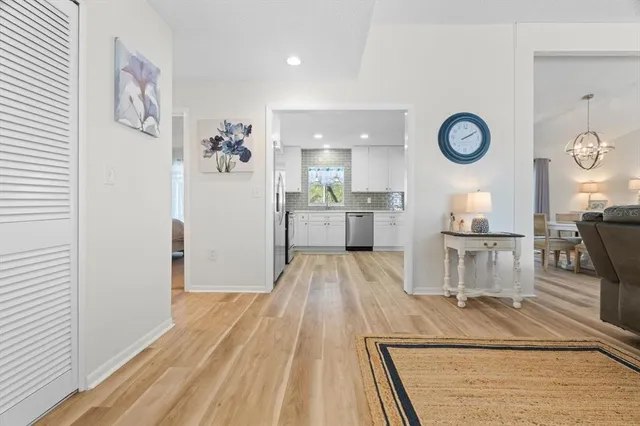 a view of a kitchen with fridge and wooden floor