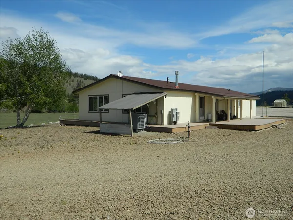 a view of a house with a yard and sitting area