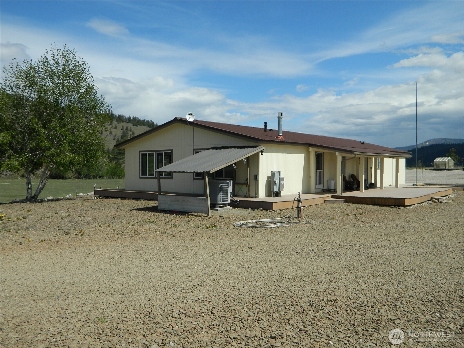 29 Duck Flats Road Tonasket, WA 98855 - Photo 1 of 25 a view of a house with a yard and sitting area