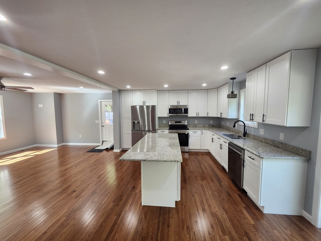 158 Lower Hampden Road Monson, MA 01057 - Photo 8 of 19 a large kitchen with stainless steel appliances granite countertop a large counter top a sink and a stove