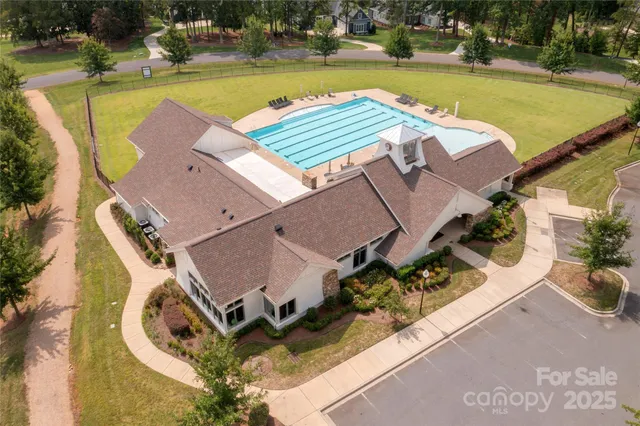 an aerial view of a house with swimming pool and outdoor space