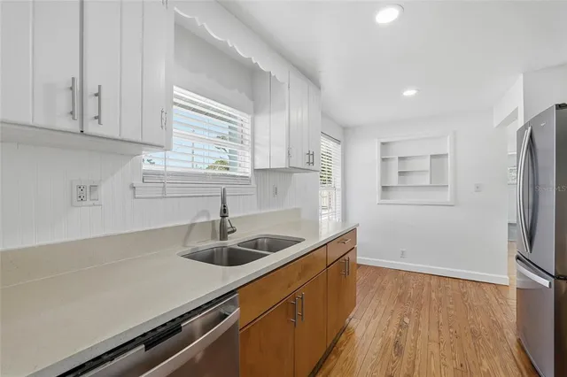 a kitchen with stainless steel appliances a sink a stove and a refrigerator
