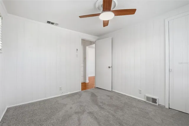 an empty room with ceiling fan